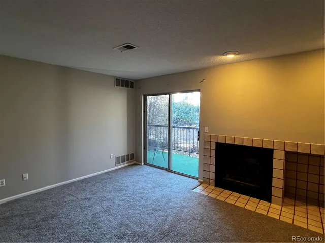 a view of an empty room with a fireplace