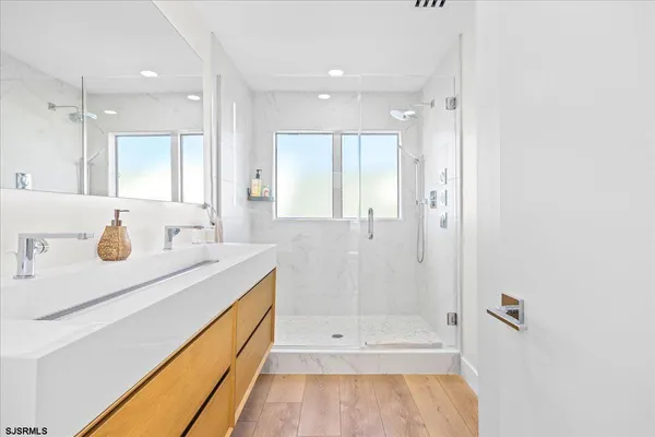 a bathroom with a sink a toilet and shower