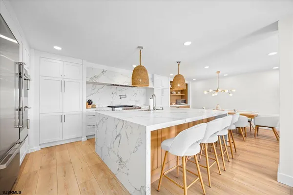 a large kitchen with kitchen island a island in the center
