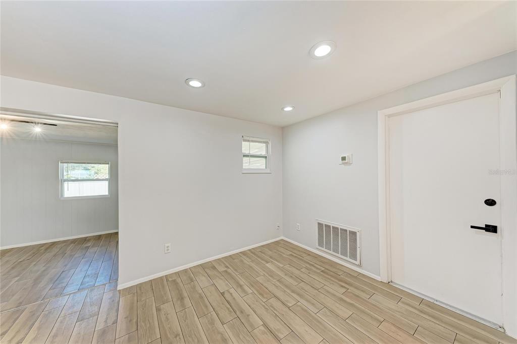 4010 South Lockwood Ridge Road Sarasota, FL 34231 - Photo 15 of 48 a view of empty room with wooden floor