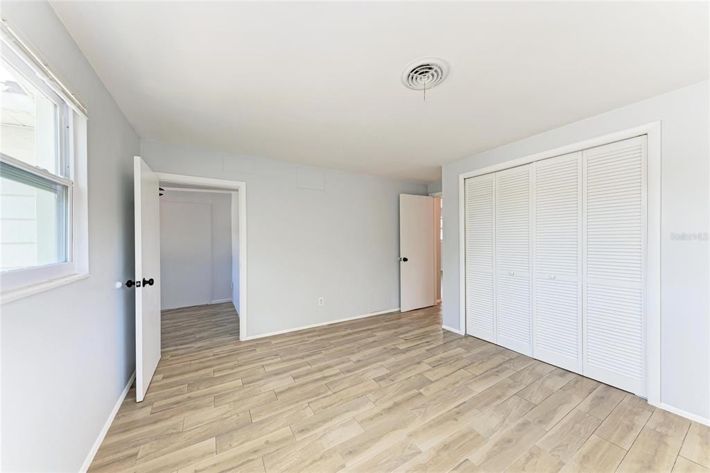4010 South Lockwood Ridge Road Sarasota, FL 34231 - Photo 17 of 48 a view of an empty room with wooden floor and a window