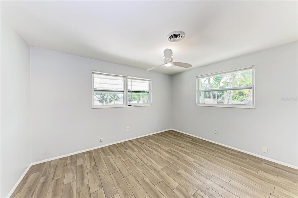 4010 South Lockwood Ridge Road Sarasota, FL 34231 - Photo 20 of 48 a view of empty room with wooden floor