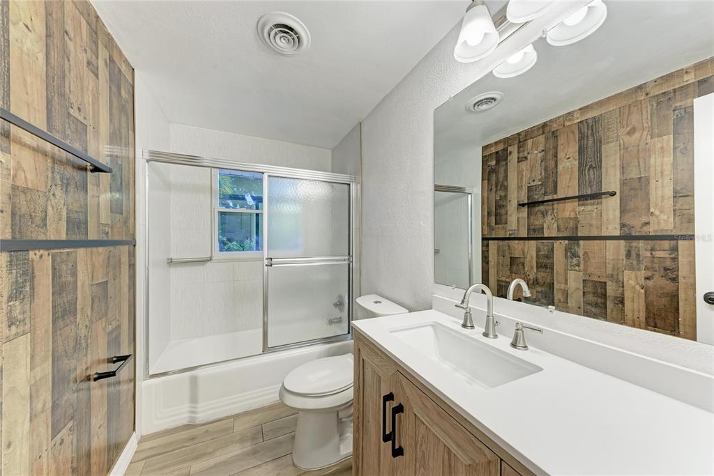 4010 South Lockwood Ridge Road Sarasota, FL 34231 - Photo 23 of 48 a bathroom with a sink toilet vanity and shower
