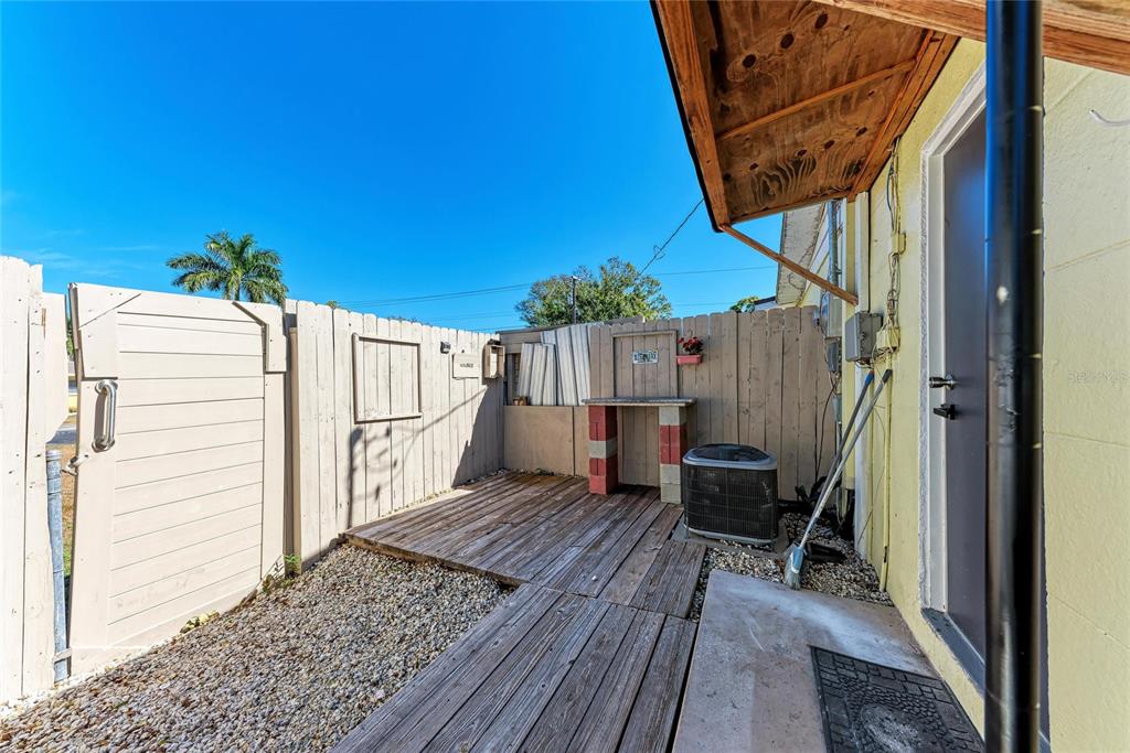 4010 South Lockwood Ridge Road Sarasota, FL 34231 - Photo 33 of 48 a view of a wooden door and a bench in balcony