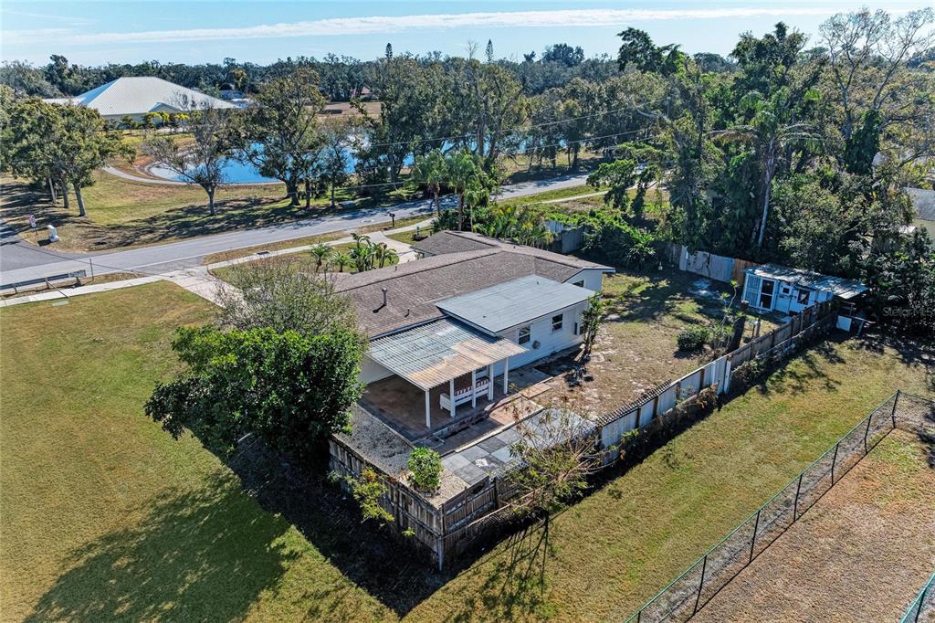 4010 South Lockwood Ridge Road Sarasota, FL 34231 - Photo 4 of 48 a view of a swimming pool with a garden