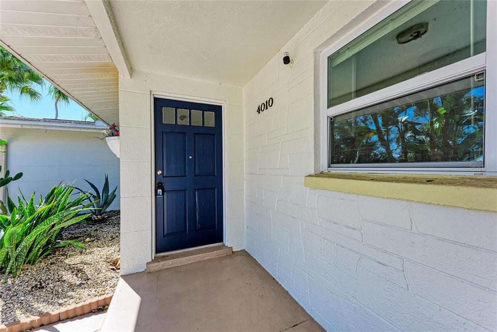 4010 South Lockwood Ridge Road Sarasota, FL 34231 - Photo 5 of 48 a view of front door and potted plants