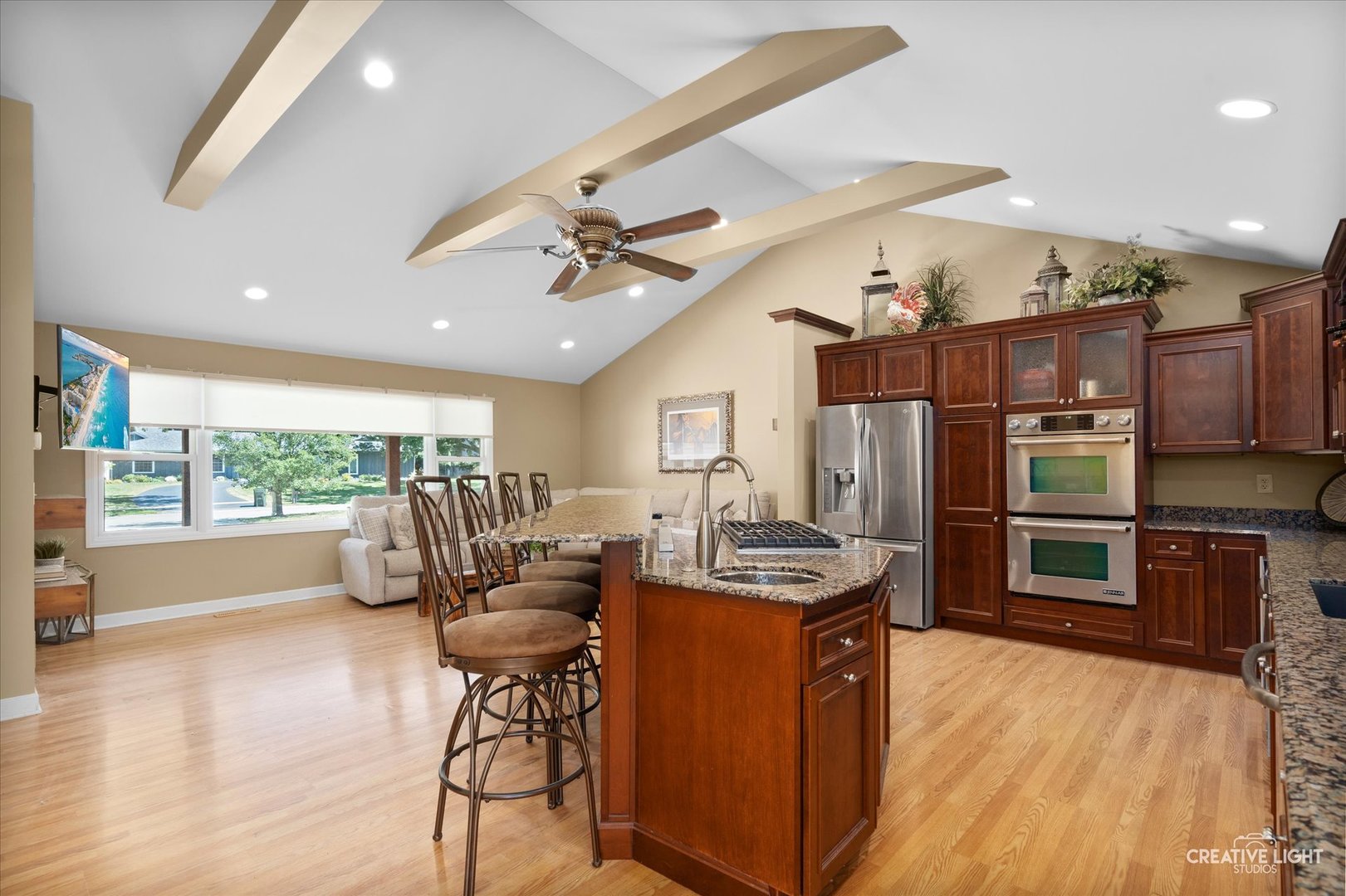 201 Pepperidge Road Naperville, IL 60540 - Photo 11 of 31 a kitchen with stainless steel appliances a stove a refrigerator a sink dishwasher with a dining table and chairs with wooden floor