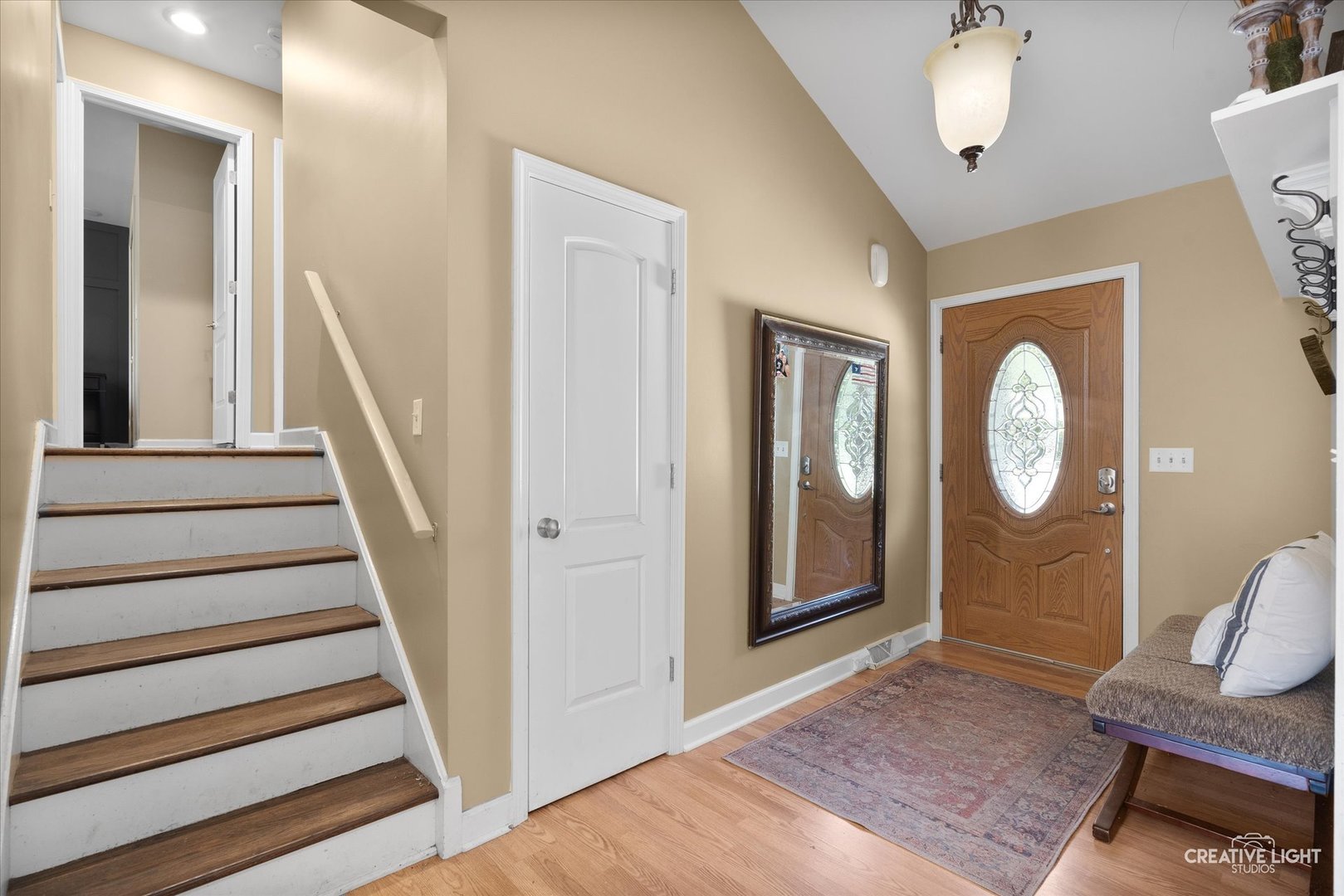 201 Pepperidge Road Naperville, IL 60540 - Photo 2 of 31 a view of a hallway with entryway wooden floor and front door
