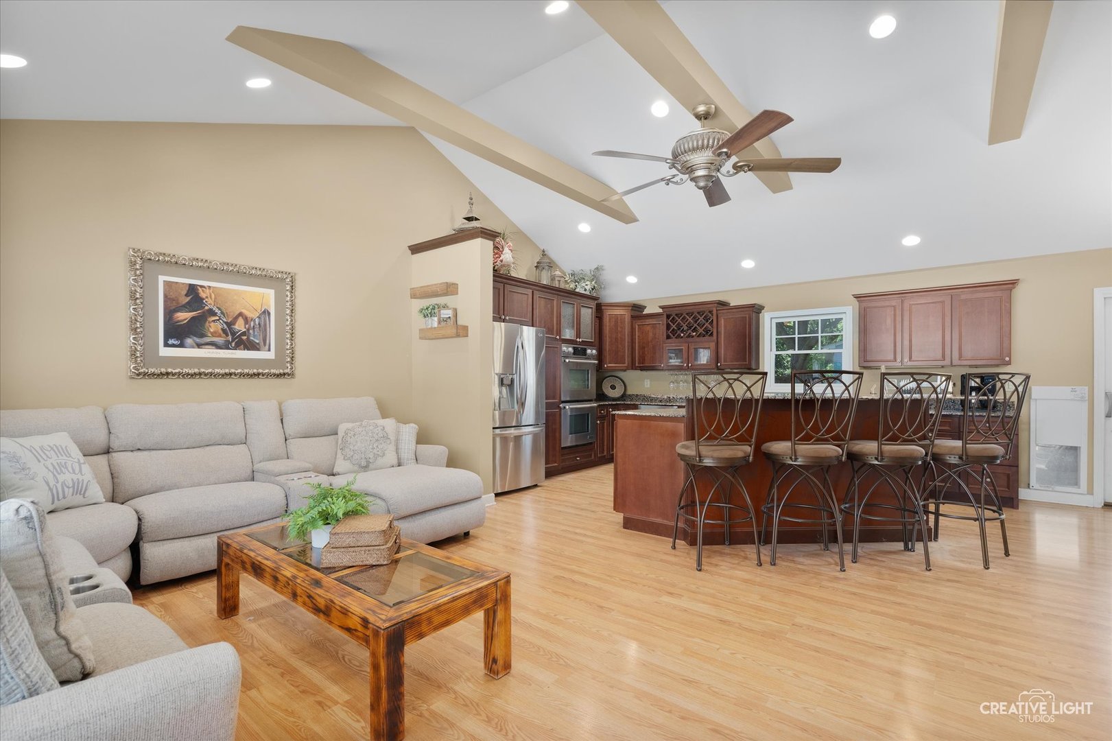 201 Pepperidge Road Naperville, IL 60540 - Photo 5 of 31 a living room with furniture kitchen view and a wooden floor
