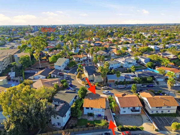 an aerial view of residential houses with outdoor space