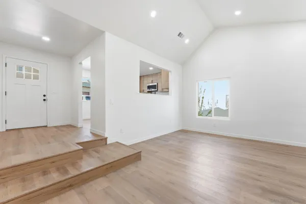 a kitchen with stainless steel appliances white cabinets and a stove top oven