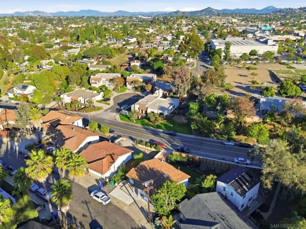 an aerial view of lake and residential houses with outdoor space