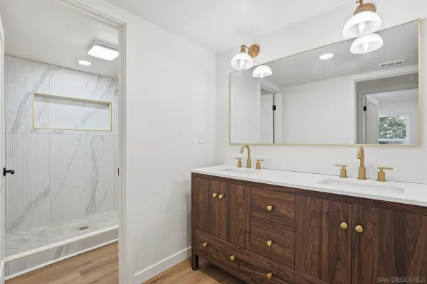 a large kitchen with stainless steel appliances granite countertop a stove a sink and a refrigerator