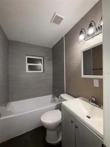 a bathroom with a sink a toilet and bathtub
