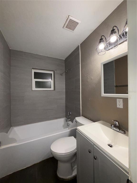 305 Marker Street Altamonte Springs, FL 32701 - Photo 14 of 15 a bathroom with a sink a toilet and bathtub