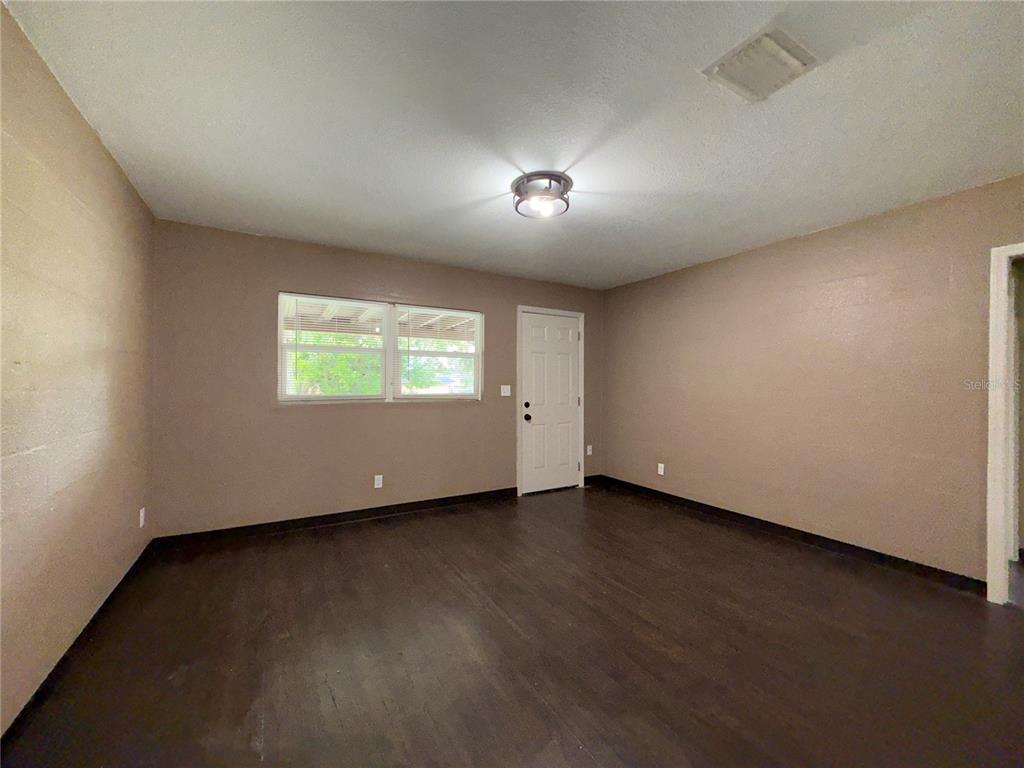 305 Marker Street Altamonte Springs, FL 32701 - Photo 2 of 15 an empty room with wooden floor and windows