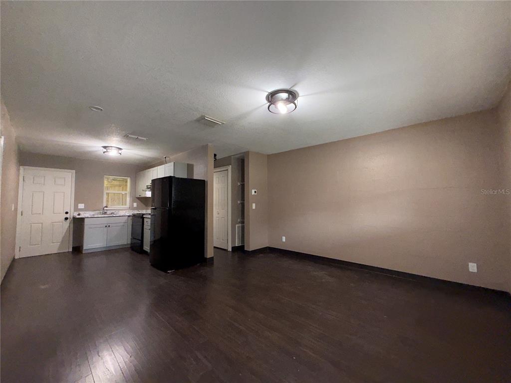 305 Marker Street Altamonte Springs, FL 32701 - Photo 6 of 15 an empty room with wooden floor and windows