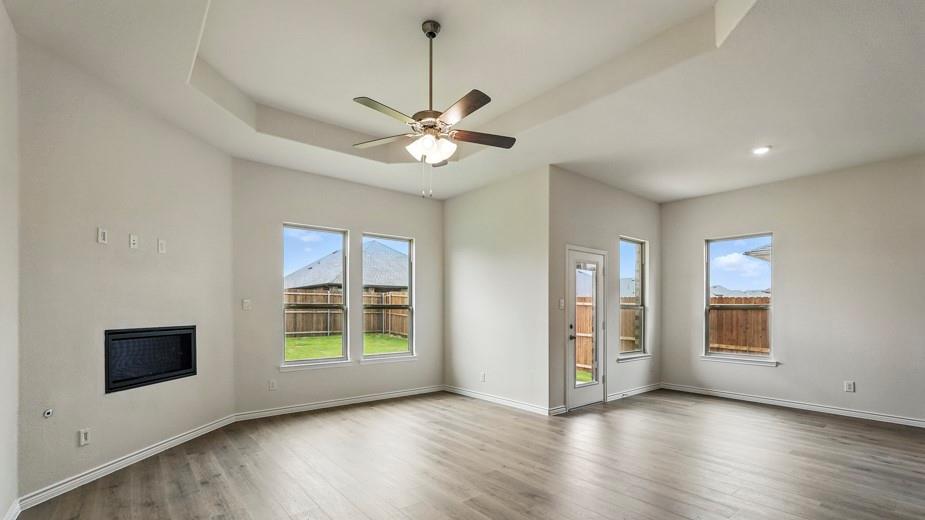 4187 Plateau Drive Forney, TX 75126 - Photo 11 of 36 a view of an empty room with a window and wooden floor