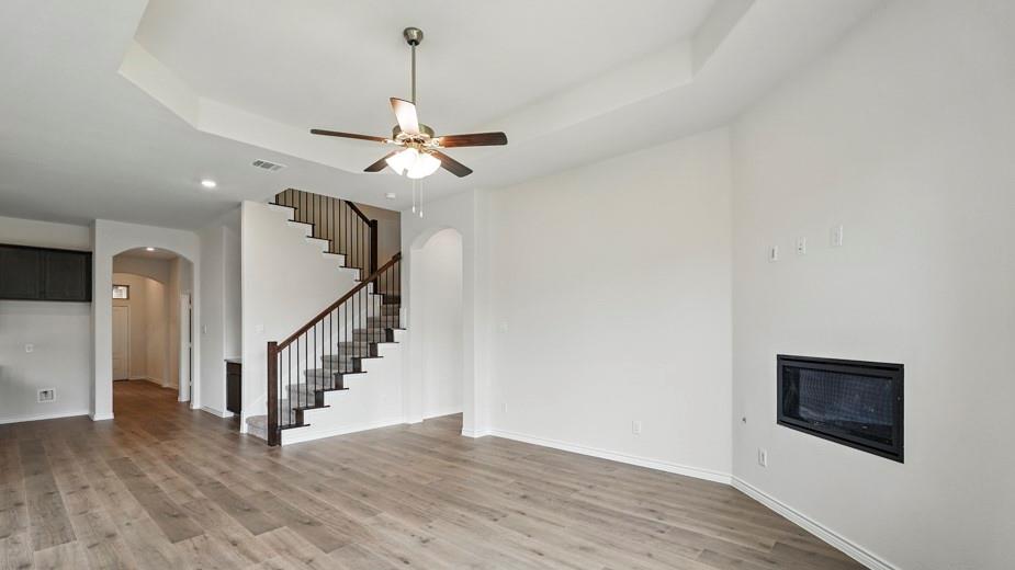 4187 Plateau Drive Forney, TX 75126 - Photo 13 of 36 a view of a livingroom with wooden floor and a ceiling fan