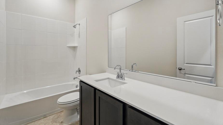 4187 Plateau Drive Forney, TX 75126 - Photo 22 of 36 a bathroom with a sink a toilet and shower