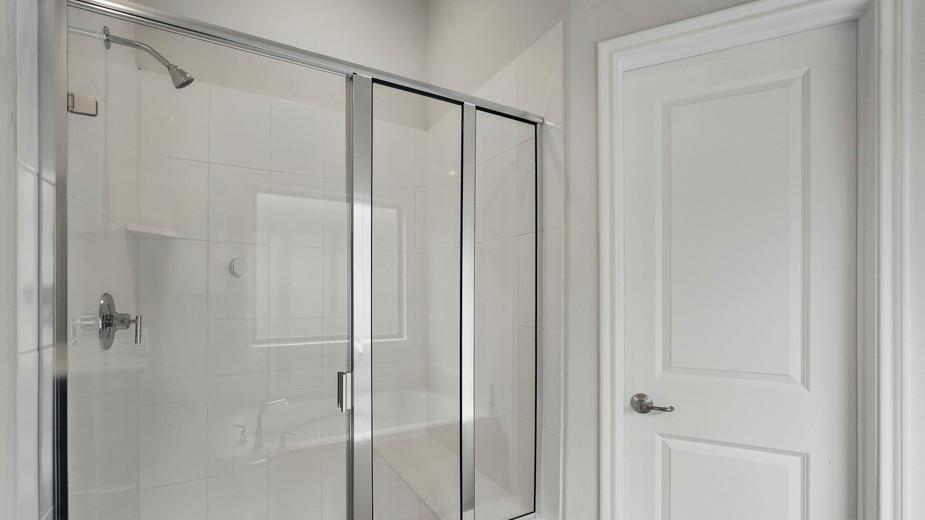 4187 Plateau Drive Forney, TX 75126 - Photo 24 of 36 a bathroom with a glass shower door