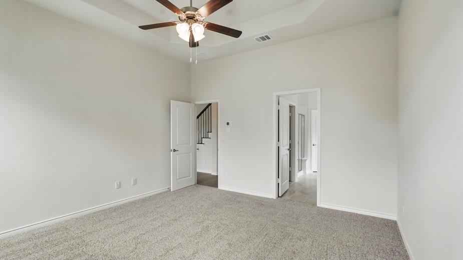 4187 Plateau Drive Forney, TX 75126 - Photo 26 of 36 an empty room with a chandelier fan and windows