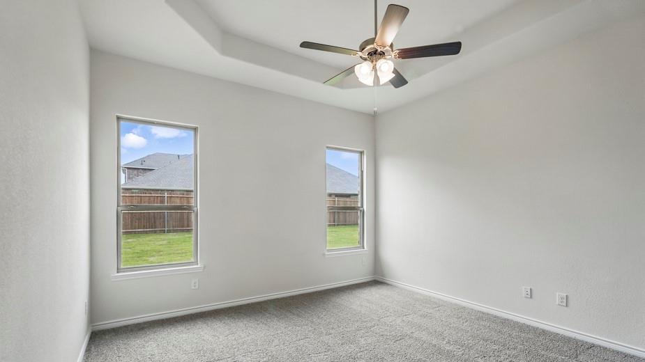 4187 Plateau Drive Forney, TX 75126 - Photo 29 of 36 an empty room with windows and fan