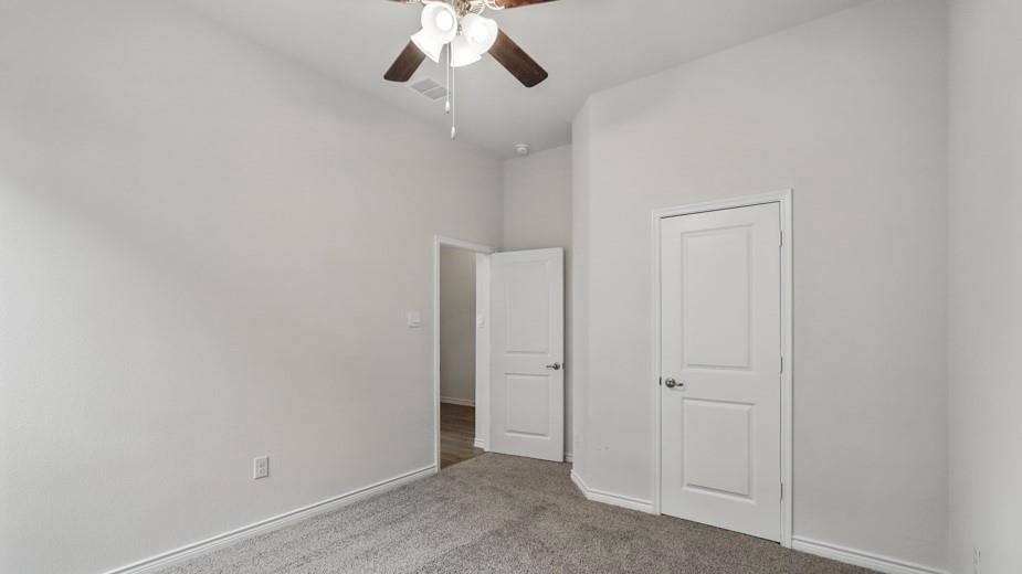 4187 Plateau Drive Forney, TX 75126 - Photo 31 of 36 an empty room with a chandelier fan
