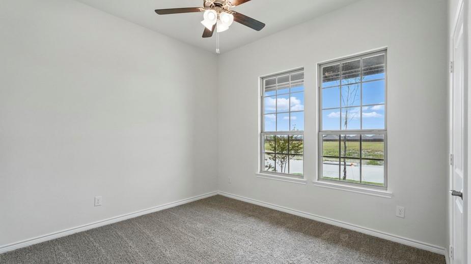 4187 Plateau Drive Forney, TX 75126 - Photo 35 of 36 an empty room with chandelier fan and windows