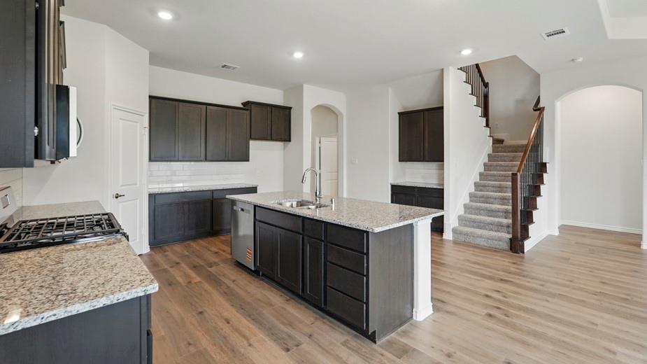 4187 Plateau Drive Forney, TX 75126 - Photo 4 of 36 a kitchen with stainless steel appliances granite countertop a sink stove and refrigerator