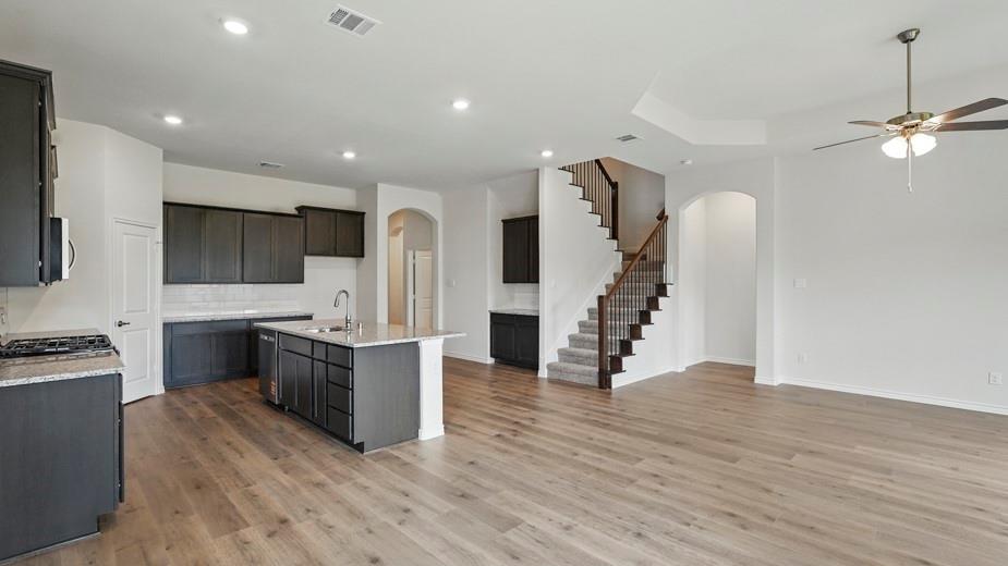 4187 Plateau Drive Forney, TX 75126 - Photo 8 of 36 a kitchen with stainless steel appliances a refrigerator and a stove top oven