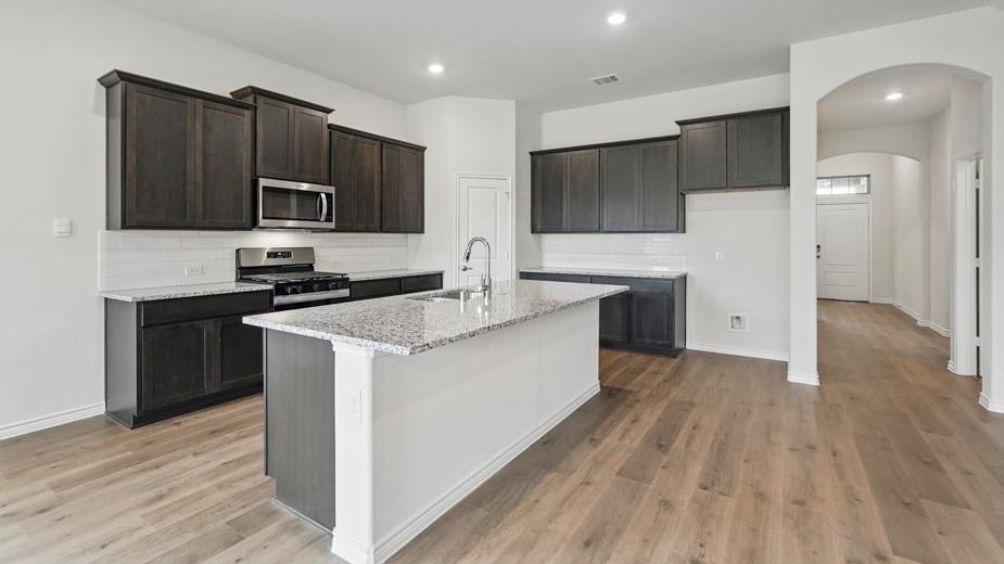 4187 Plateau Drive Forney, TX 75126 - Photo 9 of 36 a kitchen with a sink and steel appliances