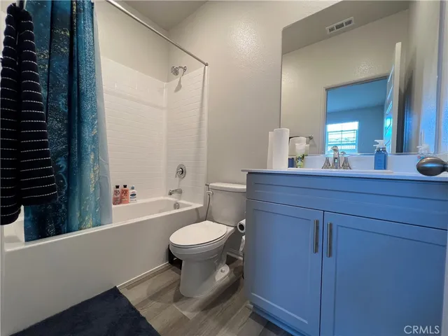 a bathroom with a sink toilet a mirror and shower