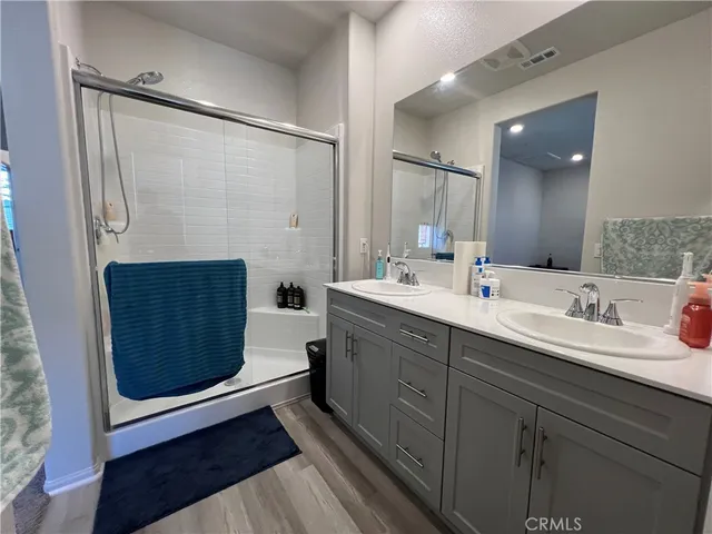 a bathroom with a double vanity sink and mirror