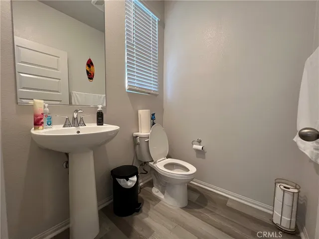 a bathroom with a sink toilet and a mirror