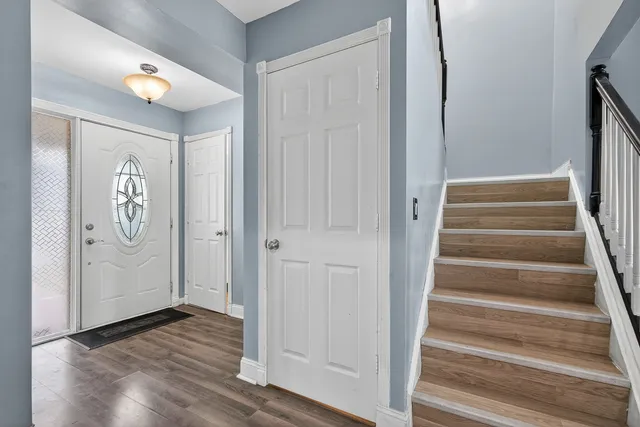 a view of an entryway with wooden floor