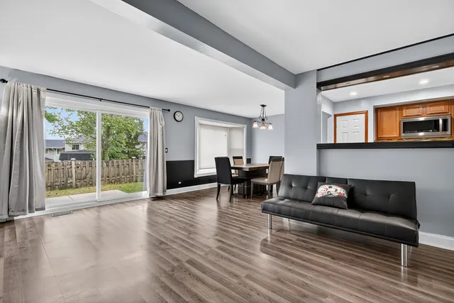 a living room with furniture and large windows