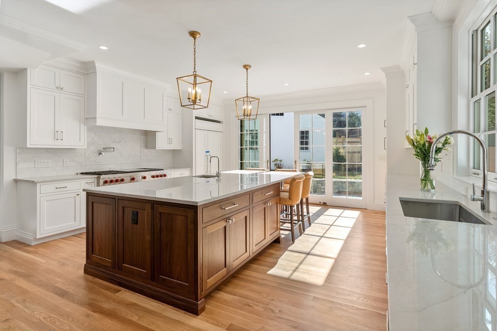 102 Dean Road Brookline, MA 02445 - Photo 8 of 38 a kitchen with stainless steel appliances granite countertop a sink a stove and a wooden floors