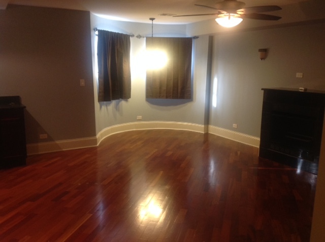 5201 South Indiana Avenue, Unit G Chicago, IL 60615 - Photo 3 of 5 a view of wooden floor and windows in a room