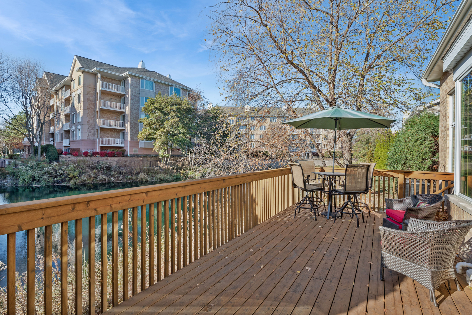 1738 Park Ridge Point Park Ridge, IL 60068 - Photo 23 of 27 a view of a roof deck with table and chairs under an umbrella with wooden floor