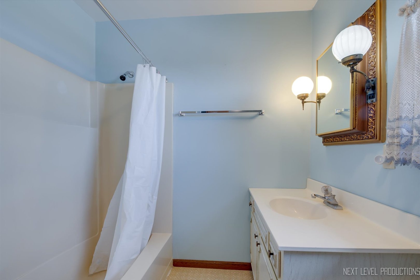 12029 Faxon Road Plano, IL 60545 - Photo 19 of 26 a bathroom with a sink a light fixture and a mirror