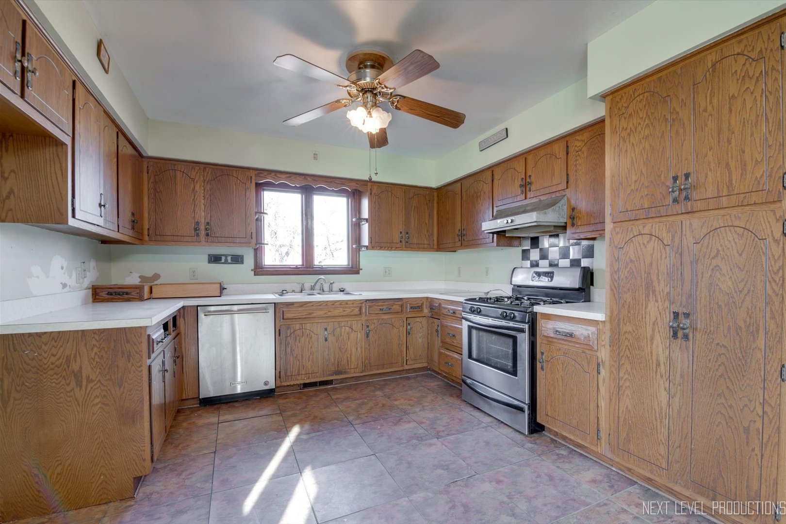 12029 Faxon Road Plano, IL 60545 - Photo 4 of 26 a kitchen with a sink stove and refrigerator