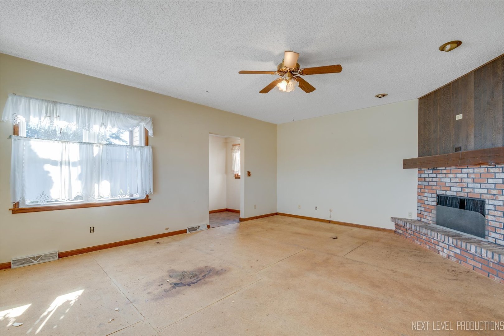 12029 Faxon Road Plano, IL 60545 - Photo 8 of 26 a view of empty room with windows and fireplace