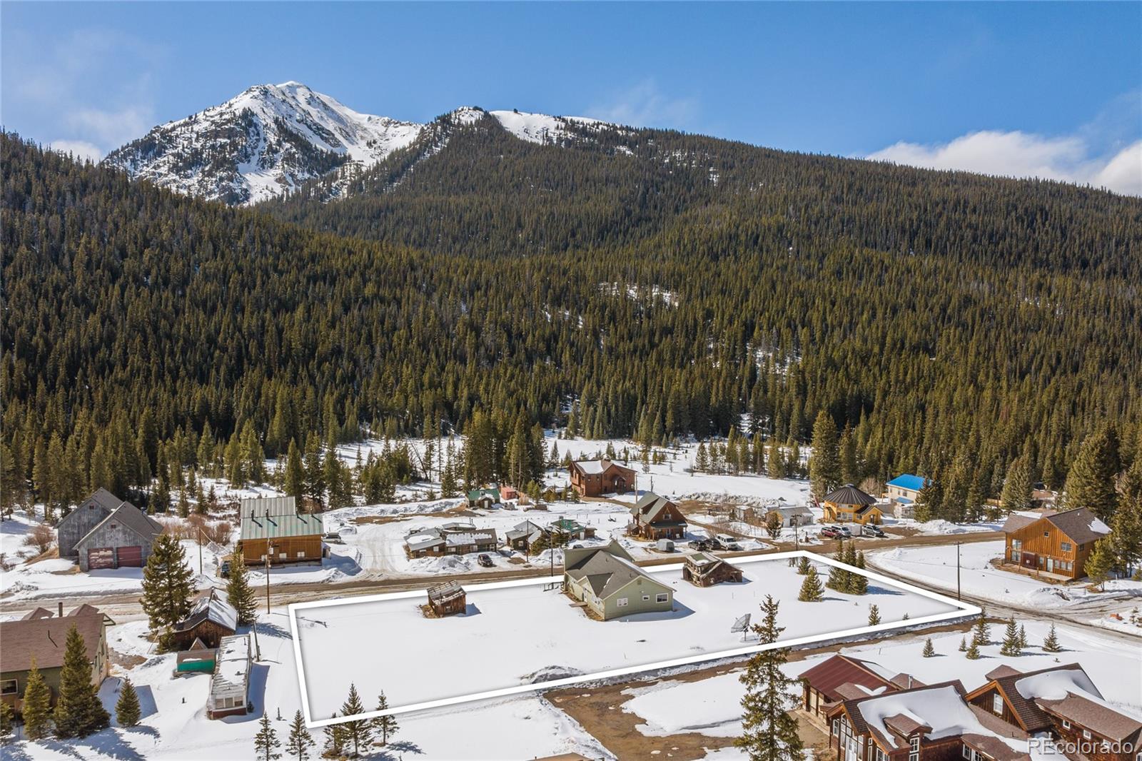 5355 Montezuma Road Montezuma, CO 80435 - Photo 1 of 50 a white house with a outdoor space and sitting space