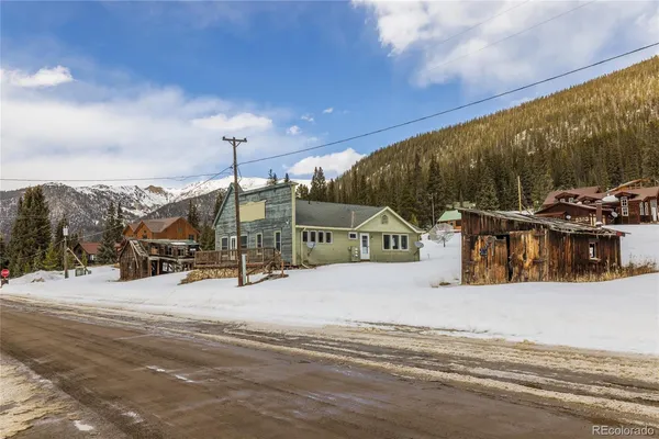 a view of a house with a snow on the road