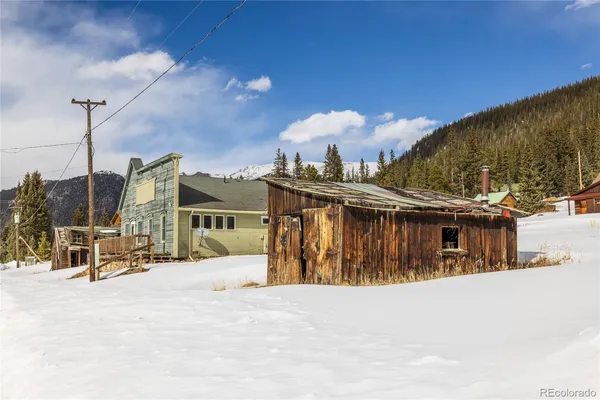 a view of a house with a snow in the yard