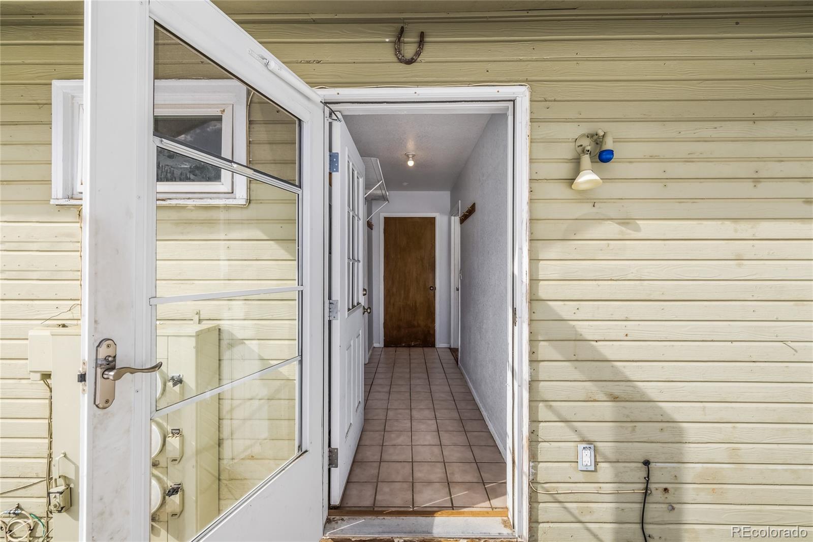 5355 Montezuma Road Montezuma, CO 80435 - Photo 21 of 50 a view of a hallway with wooden walls