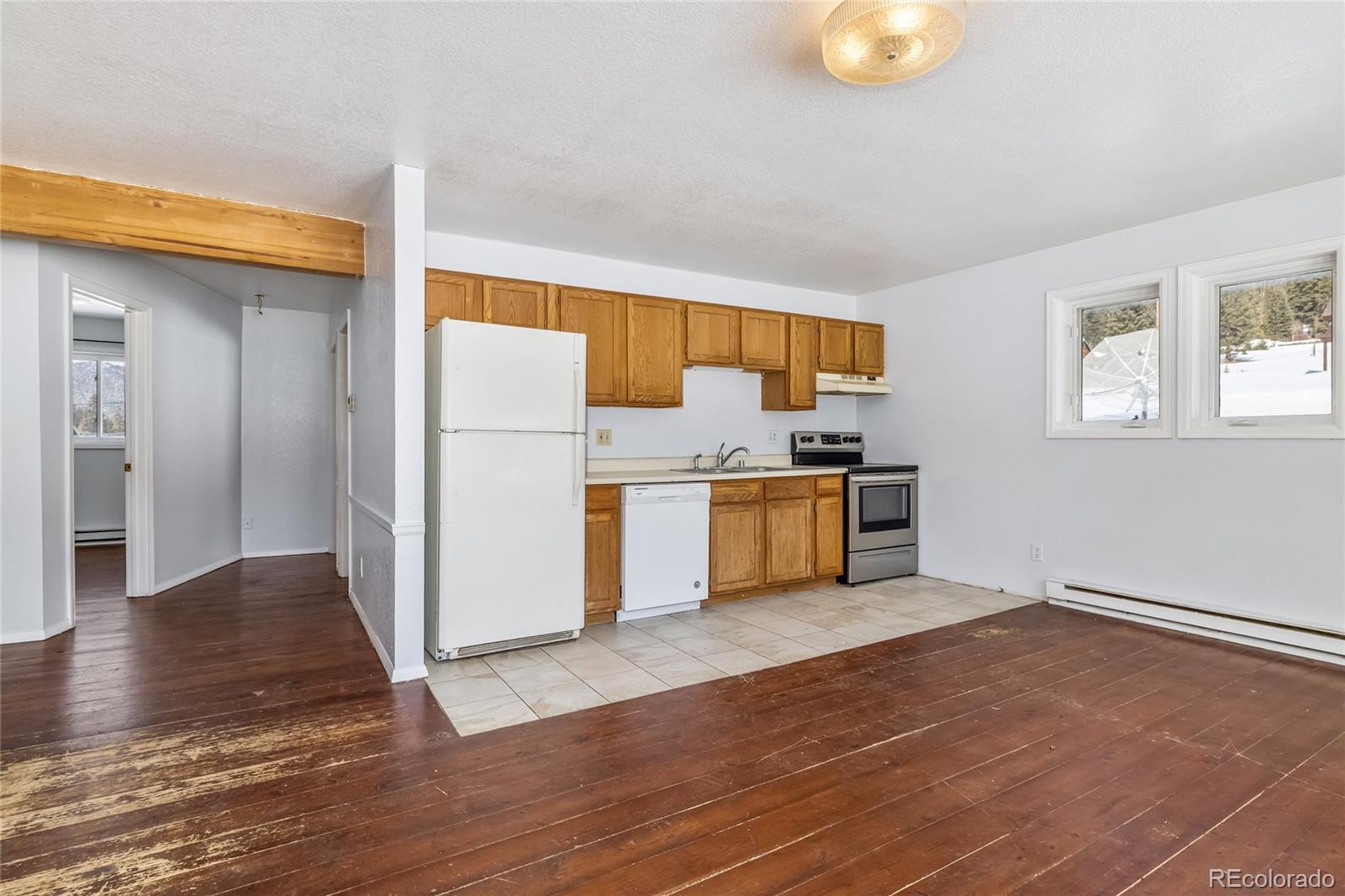 5355 Montezuma Road Montezuma, CO 80435 - Photo 22 of 50 a kitchen with a refrigerator and a stove top oven