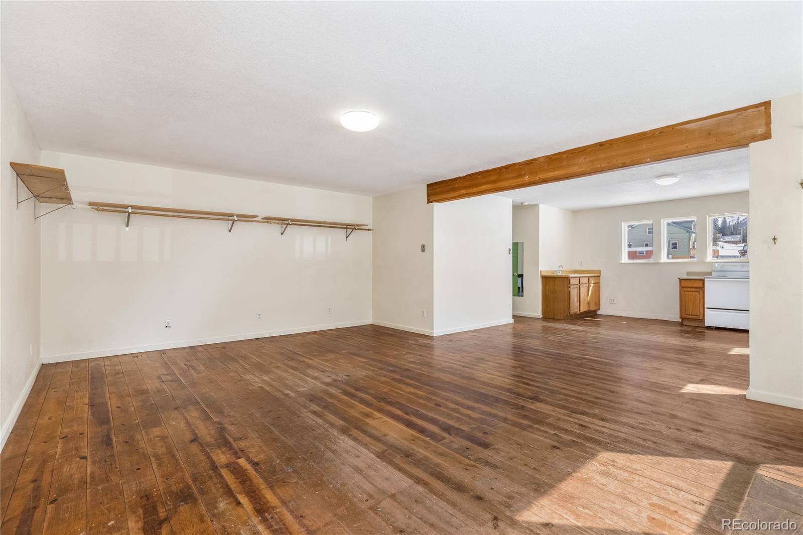 5355 Montezuma Road Montezuma, CO 80435 - Photo 35 of 50 a view of empty room with wooden floor and fan