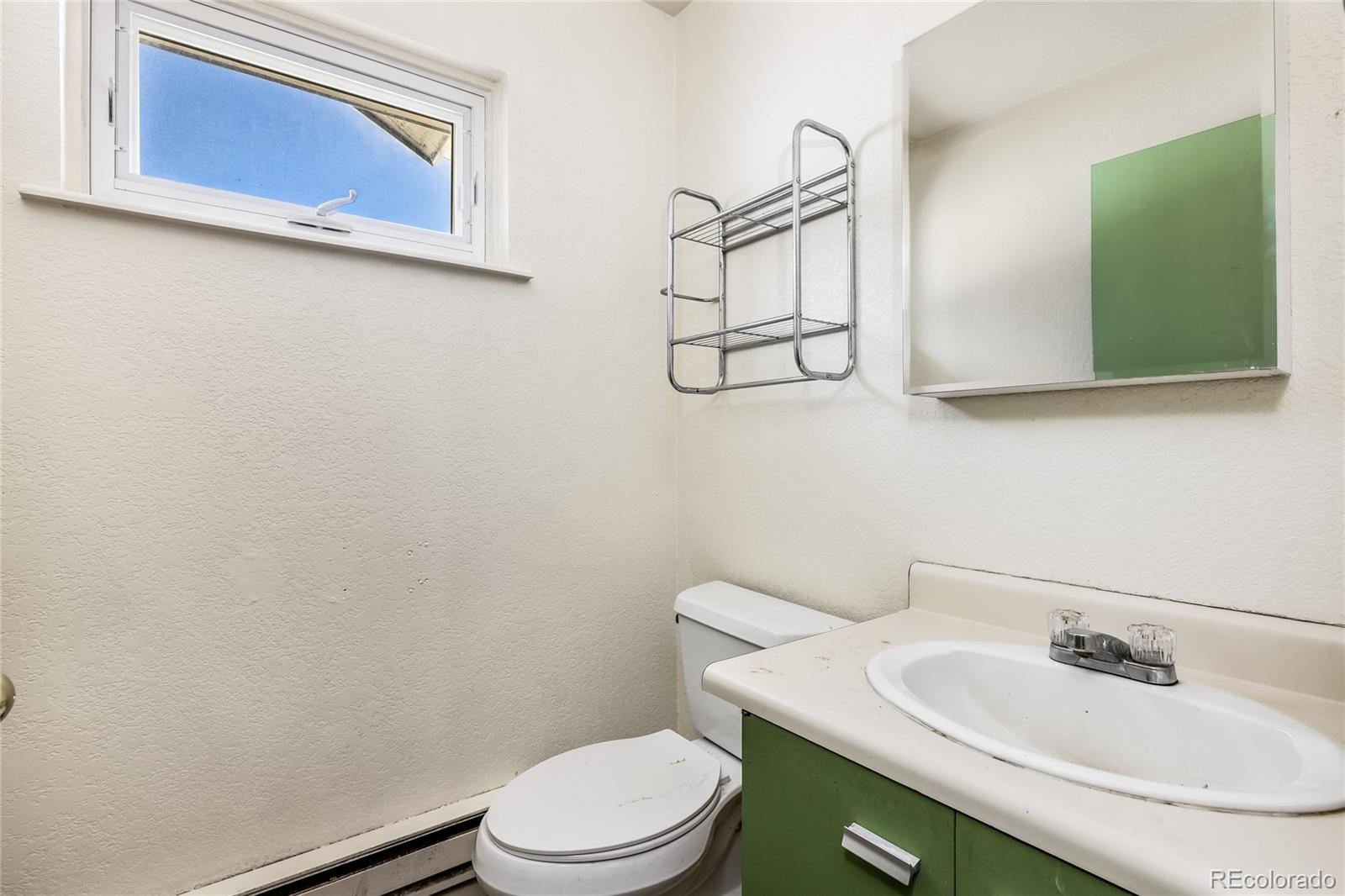 5355 Montezuma Road Montezuma, CO 80435 - Photo 42 of 50 a bathroom with a toilet sink and mirror